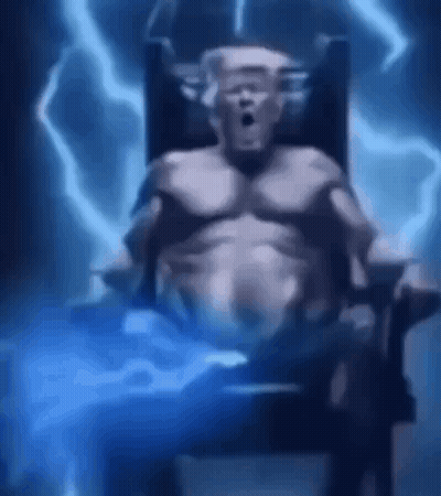 Man Sitting In Chair With Lightning Behind Him GIF