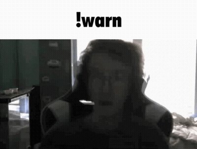 Man Sitting In Chair With Microphone And Warn Text GIF