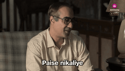 Man Sitting In Chair With Paise Nikalye GIF
