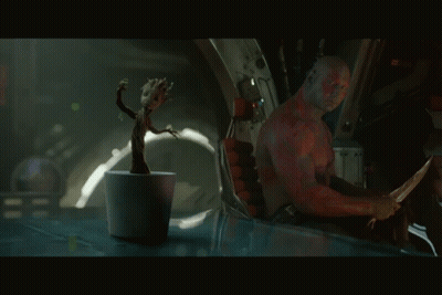 Man Sitting In Chair With Plant GIF