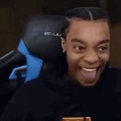 Man Sitting In Chair With Tongue Out GIF