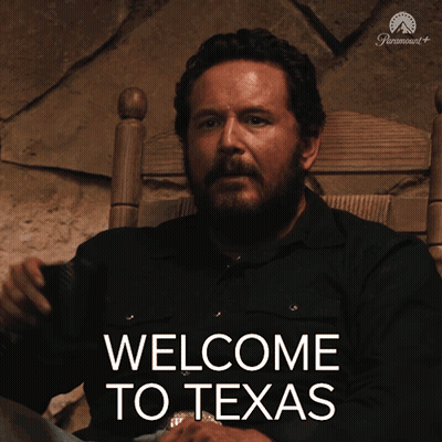 Man Sitting In Chair With Welcome To Texas On Screen GIF