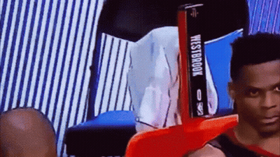 Man Sitting In Chair With Westbrook Sign GIF