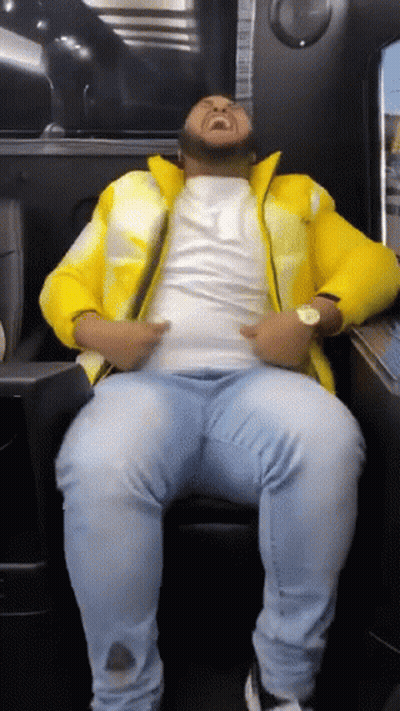 Man Sitting in Chair with Yellow Jacket and Blue Jeans