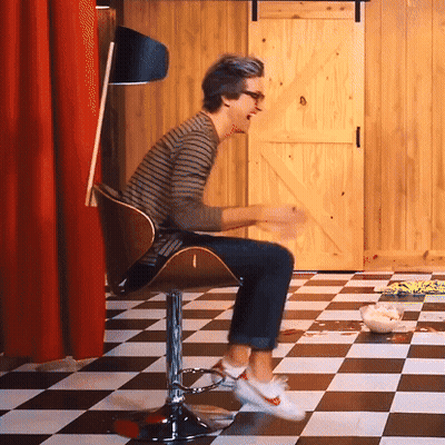 Man Sitting In Checkerboard Floor GIF