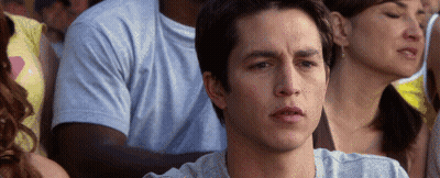 Man Sitting In Crowd Looking At Something GIF
