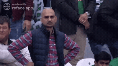 Man Sitting In Crowd With Hands On Hips GIF