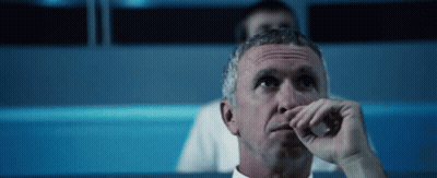 Man Sitting In Dark Room Hand To Nose GIF