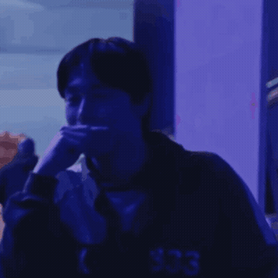 Man Sitting In Dark Room With Blue Light GIF