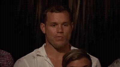 Man Sitting In Dark Room With Other Men GIF
