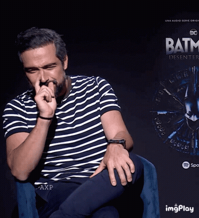 Man Sitting In Front Of Batman Poster GIF