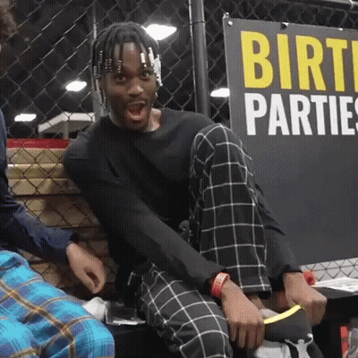Man Sitting In Front Of Birth Parties Sign GIF