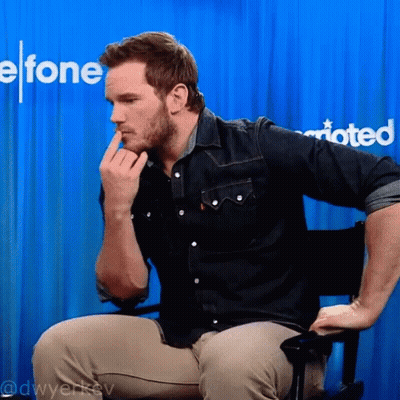 Man Sitting In Front Of Blue Curtain With Efone GIF