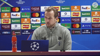 Man Sitting in Front of Champions League Ad