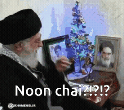 Man Sitting In Front Of Christmas Tree Noon Chai GIF