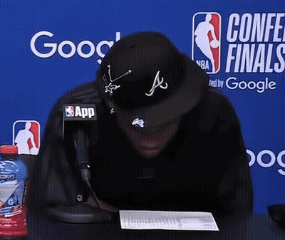 Man Sitting In Front Of Conference Finals Banner GIF