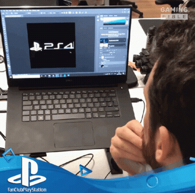 Man Sitting In Front Of Dell Laptop With PS4 Logo GIF