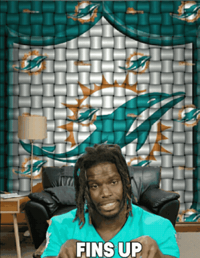 Man Sitting In Front Of Dolphin Wall Saying Fins Up GIF