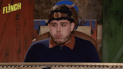Man Sitting In Front Of Flinch Sign GIF