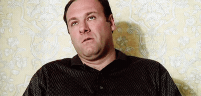 Man Sitting In Front Of Floral Wallpaper GIF