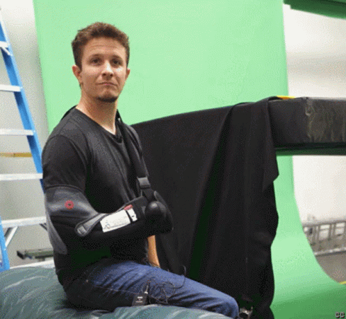 Man Sitting In Front Of Green Screen With Letters CB GIF