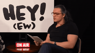 Man Sitting In Front Of Hey (Ew) Sign GIF