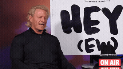Man Sitting In Front Of Hey Ew Sign GIF