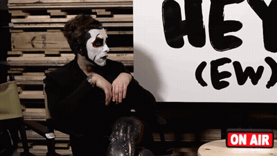 Man Sitting In Front Of Hey Ew Sign GIF
