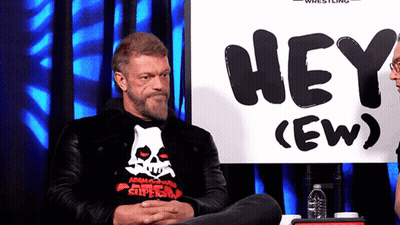 Man Sitting In Front Of Hey Sign GIF