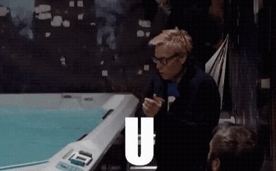 Man Sitting In Front Of Hot Tub With Letter U GIF