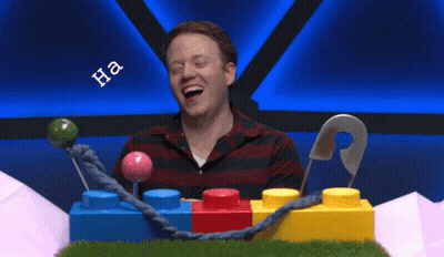 Man Sitting In Front Of Lego Blocks With Ummm Shirt GIF