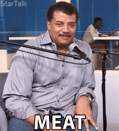 Man Sitting In Front Of Microphone With Meat GIF
