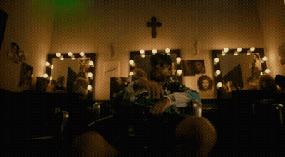 Man Sitting In Front Of Mirror With Cross GIF