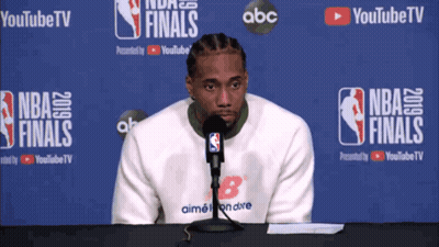 Man Sitting In Front Of NBA Finals Banner GIF