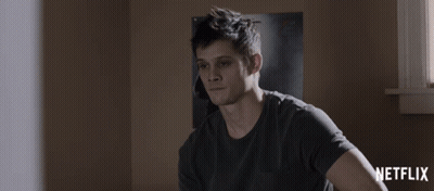 Man Sitting In Front Of Netflix Poster GIF