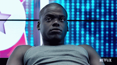 Man Sitting In Front Of Netflix Sign GIF
