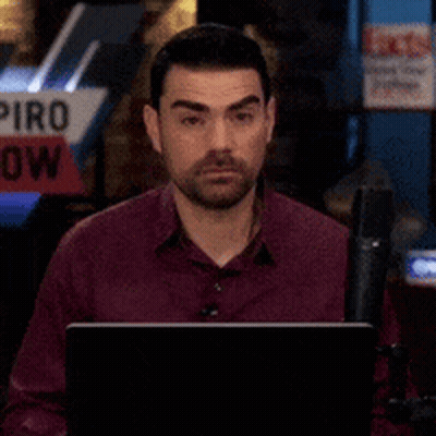 Man Sitting In Front Of Piro Show Sign GIF