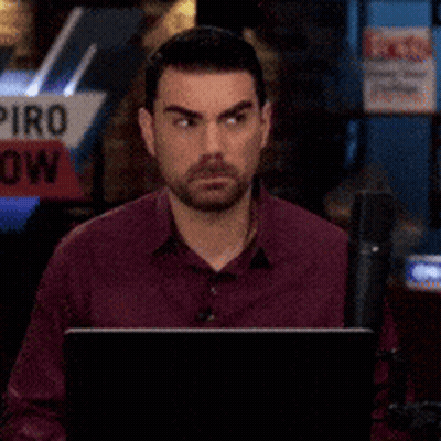 Man Sitting In Front Of Piro Sign GIF