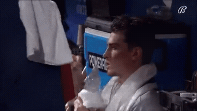 Man Sitting In Front Of Powerade Cooler GIF