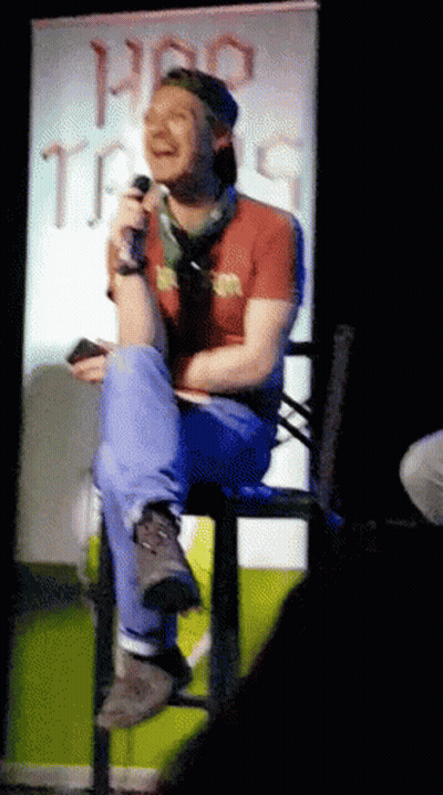 Man Sitting In Front Of Pro Tips Sign GIF