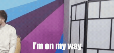 Man Sitting In Front Of Purple Wall With I M On My Way GIF