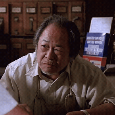 Man Sitting In Front Of Register To Vote Sign GIF