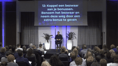 Man Sitting In Front Of Screen Saying Koppel Een Bezwaard Aan Je Bonussen GIF