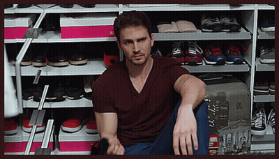 Man Sitting in Front of Shoe Rack With I'm Sorry Box