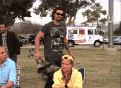 Man Sitting In Front Of Tent With Fire Bucket GIF