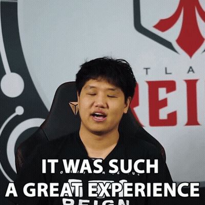 Man Sitting in Front of Tla Ei Sign