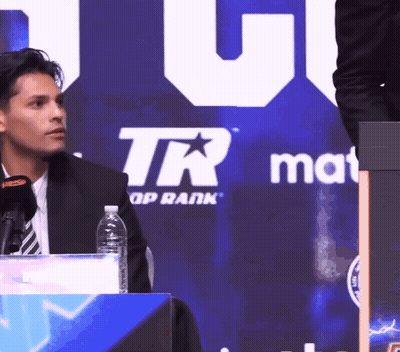 Man Sitting In Front Of TR Group Rank Sign GIF