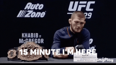 Man Sitting In Front Of UFC Sign GIF