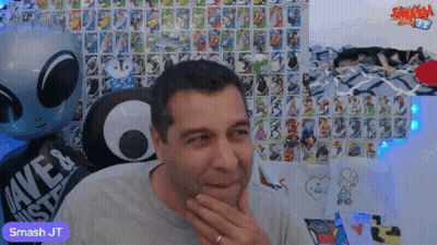 Man Sitting In Front Of Wall With Smash Jt GIF