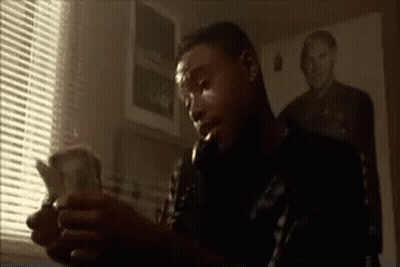Man Sitting In Front Of Window Holding Money GIF